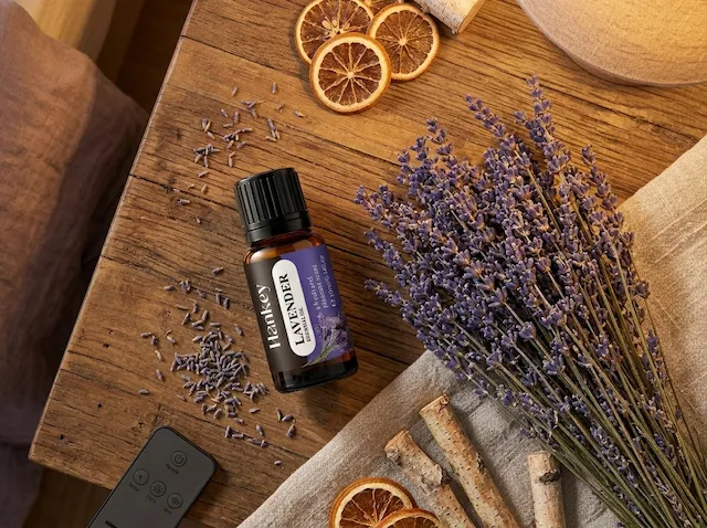 Lavender essential oil bottle flat lay with dried lavender flowers