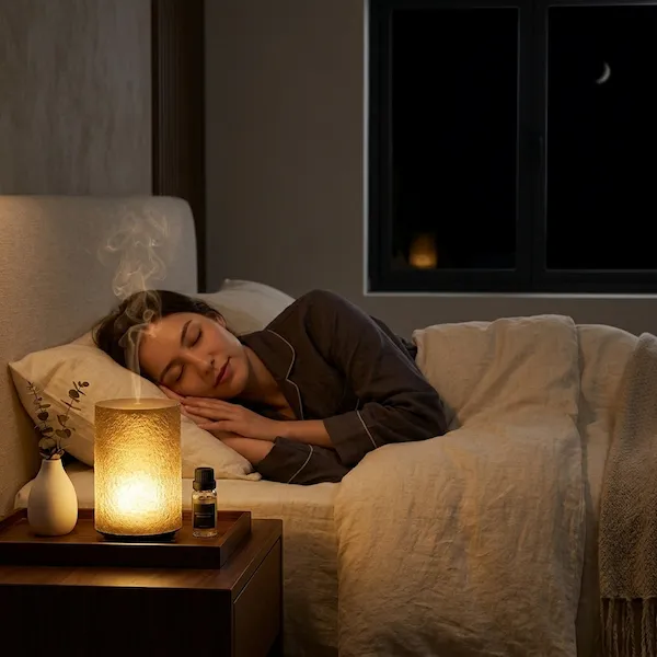 Woman sleeping beside MISTVO flame diffuser on nightstand
