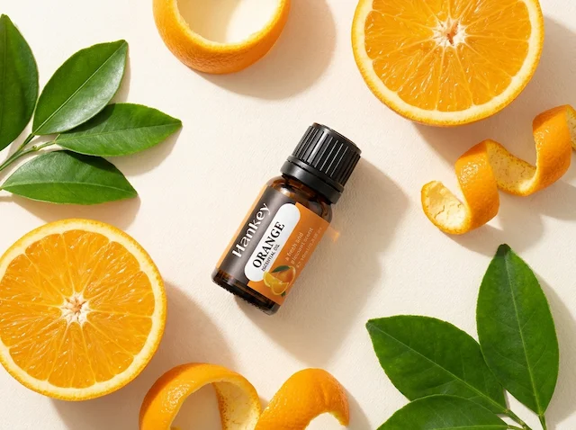 Sweet Orange oil bottle flat lay with fresh orange fruit and peel